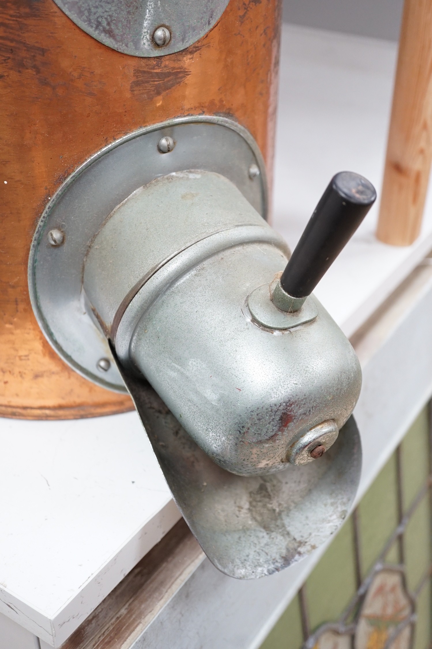 A copper coffee bean dispenser. 60cm high